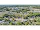 An aerial view of the property showing the landscape, roadway, and nearby retail businesses at 9236 Suncoast Terrace, Hudson, FL 34667