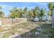 Spacious backyard with a partial wooden fence and some outbuildings on the property at 9236 Suncoast Terrace, Hudson, FL 34667