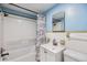 Bright bathroom with a tub-shower combo, vanity, and tile accents at 9236 Suncoast Terrace, Hudson, FL 34667