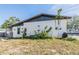 Exterior of a single story home with lush foliage growing near the foundation at 9236 Suncoast Terrace, Hudson, FL 34667