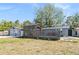 View of the side of the house with garage and enclosed wooden patio at 9236 Suncoast Terrace, Hudson, FL 34667
