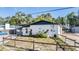 Charming single-story white brick home with a cozy front yard and a wooden fence at 9236 Suncoast Terrace, Hudson, FL 34667