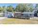 View of the side of the house with garage and enclosed wooden patio at 9236 Suncoast Terrace, Hudson, FL 34667