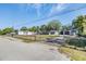 This property features multiple buildings, a gated yard, and mature trees at 9236 Suncoast Terrace, Hudson, FL 34667