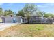 Charming single story home with gray exterior, brick accents, and an enclosed patio at 9236 Suncoast Terrace, Hudson, FL 34667