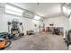 Spacious garage featuring white walls, and an assortment of tools and equipment at 9236 Suncoast Terrace, Hudson, FL 34667