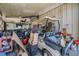 Cluttered garage space with assorted tools, boxes, and equipment at 9236 Suncoast Terrace, Hudson, FL 34667