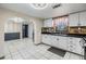Bright kitchen featuring white cabinets, stainless steel appliances, stone backsplash and tile flooring at 9236 Suncoast Terrace, Hudson, FL 34667