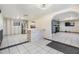 Open floorplan featuring the kitchen, living room, bar, and stainless steel refrigerator at 9236 Suncoast Terrace, Hudson, FL 34667