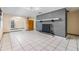 Bright living room featuring tile floors, a fireplace, and an arched entry, filled with natural light at 9236 Suncoast Terrace, Hudson, FL 34667