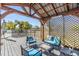 Inviting outdoor deck area with comfortable seating, pergola, and lattice providing shade and a relaxing ambiance at 9236 Suncoast Terrace, Hudson, FL 34667