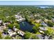 Aerial view of waterfront townhomes on a peaceful lake surrounded by mature trees in a residential neighborhood at 10605 Carrollbrook Ln, Tampa, FL 33618