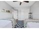 Comfortable bedroom with twin beds, double closets, and blue patterned rug at 10605 Carrollbrook Ln, Tampa, FL 33618