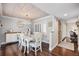 Elegant dining room with a white table, decorative chairs, and a unique chandelier, perfect for gatherings at 10605 Carrollbrook Ln, Tampa, FL 33618