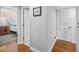 Bright hallway with hardwood floors, multiple doors and an open view to the bedroom at 10605 Carrollbrook Ln, Tampa, FL 33618