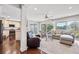 Bright living room featuring large windows with a view and comfortable seating arrangements at 10605 Carrollbrook Ln, Tampa, FL 33618