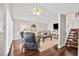 Bright living room with hardwood floors, vaulted ceiling, and a staircase leading to the upper level at 10605 Carrollbrook Ln, Tampa, FL 33618