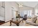 Bright living room with hardwood floors, vaulted ceiling, and a comfortable seating arrangement at 10605 Carrollbrook Ln, Tampa, FL 33618