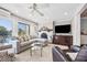 Cozy living room with a fireplace, comfortable sofa, and large windows overlooking the water at 10605 Carrollbrook Ln, Tampa, FL 33618