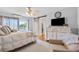 Relaxing main bedroom with ceiling fan, TV, and lake view at 10605 Carrollbrook Ln, Tampa, FL 33618