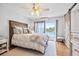 Serene main bedroom with lake view, ceiling fan, and barn door at 10605 Carrollbrook Ln, Tampa, FL 33618