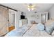 Inviting main bedroom features a barn door, flat screen, and ceiling fan at 10605 Carrollbrook Ln, Tampa, FL 33618