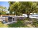 A shaded community picnic area featuring charcoal grill and lake access at 10605 Carrollbrook Ln, Tampa, FL 33618