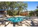 Community pool featuring mature landscaping, a sun deck, and seating at 10605 Carrollbrook Ln, Tampa, FL 33618