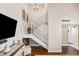 Modern staircase with white railings, complemented by dark wood flooring and stylish light fixtures at 10605 Carrollbrook Ln, Tampa, FL 33618