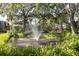 Community water feature with a fountain surrounded by lush landscaping at 10605 Carrollbrook Ln, Tampa, FL 33618