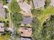 Aerial view of the property showcasing its landscaping, roof, nearby neighborhood streets and surrounding mature trees at 1003 Teal Pointe, Tarpon Springs, FL 34689