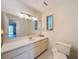 Bathroom with a large mirror, tile floors, natural light, and a toilet at 1003 Teal Pointe, Tarpon Springs, FL 34689