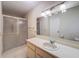 Bathroom featuring a shower over the tub and a white single-sink vanity at 1003 Teal Pointe, Tarpon Springs, FL 34689