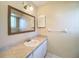 Bathroom featuring a single sink vanity and a large framed mirror at 1003 Teal Pointe, Tarpon Springs, FL 34689