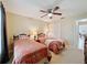 Shared bedroom with two twin beds, ceiling fan, and closet at 1003 Teal Pointe, Tarpon Springs, FL 34689