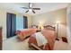 Cozy bedroom with two twin beds, a ceiling fan, and a closet for storage at 1003 Teal Pointe, Tarpon Springs, FL 34689