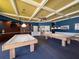 Billiard room featuring two pool tables, overhead lighting, and built-in shelving at 1003 Teal Pointe, Tarpon Springs, FL 34689