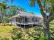 Exterior angle of house featuring a screened-in porch at 1003 Teal Pointe, Tarpon Springs, FL 34689