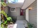 Inviting front entrance with colorful landscaping and a charming front door at 1003 Teal Pointe, Tarpon Springs, FL 34689