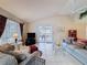 Living room featuring tile floors, vaulted ceilings, comfortable seating, and view to the outdoor deck at 1003 Teal Pointe, Tarpon Springs, FL 34689