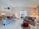 Spacious living room featuring high ceilings, tile flooring, and comfortable furnishings at 1003 Teal Pointe, Tarpon Springs, FL 34689