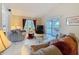 Cozy living room with comfortable seating, tile floors, vaulted ceilings, and sliding doors to outdoor deck at 1003 Teal Pointe, Tarpon Springs, FL 34689