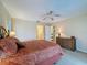 The spacious main bedroom boasts carpet floors, ceiling fan, and a large dresser at 1003 Teal Pointe, Tarpon Springs, FL 34689
