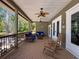 Covered patio featuring comfortable seating, rocking chairs, and ceiling fans at 1003 Teal Pointe, Tarpon Springs, FL 34689