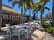 Seating areas provide a relaxing space by the community pool, complemented by lush landscaping and palm trees at 1003 Teal Pointe, Tarpon Springs, FL 34689