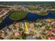 Aerial view of a charming home with lush landscaping, lakeside views, and a circular driveway in a beautiful neighborhood at 10528 Bermuda Isle Dr, Tampa, FL 33647