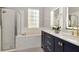 Bathroom featuring a soaking tub, separate glass enclosed shower, double vanity, and modern fixtures at 10528 Bermuda Isle Dr, Tampa, FL 33647