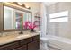 Bathroom boasts a granite countertop, a framed mirror, and modern fixtures for a luxurious experience at 10528 Bermuda Isle Dr, Tampa, FL 33647