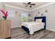 Bright bedroom with a blue headboard, gray walls, and hardwood floors creates a serene retreat at 10528 Bermuda Isle Dr, Tampa, FL 33647