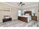 Bedroom featuring light wood flooring and a comfy bed with a padded headboard at 10528 Bermuda Isle Dr, Tampa, FL 33647